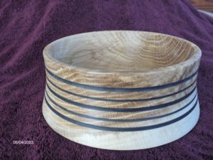 This bowl is white oak, with black epoxy putty inlaid to try to distract from the horrible shape. Didn't work out so well...